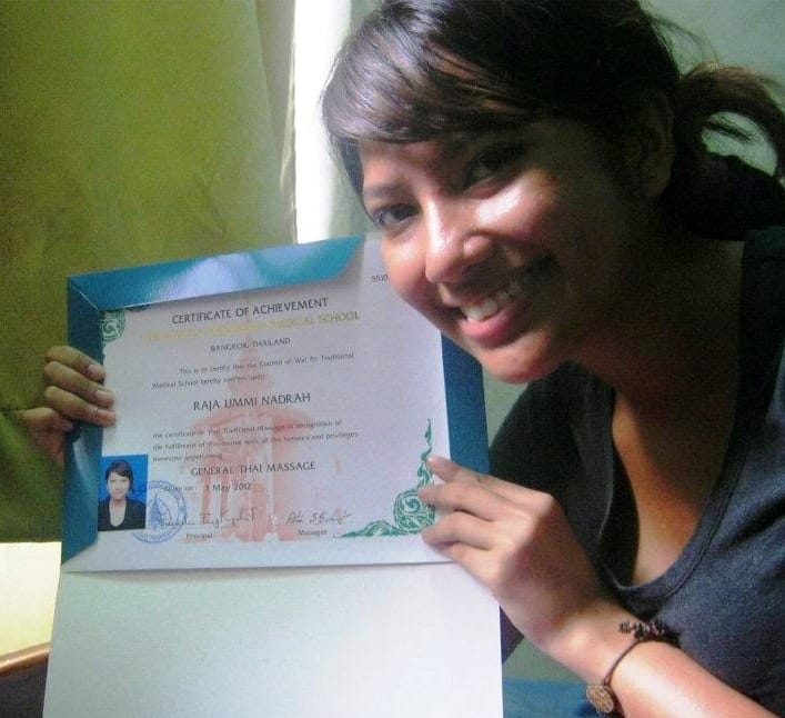 Me holding my Thai massage certificate